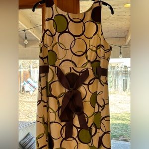 Beautiful green polka dot mid length with stunning brown belt and bow.